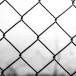 grayscale photo of chain link fence