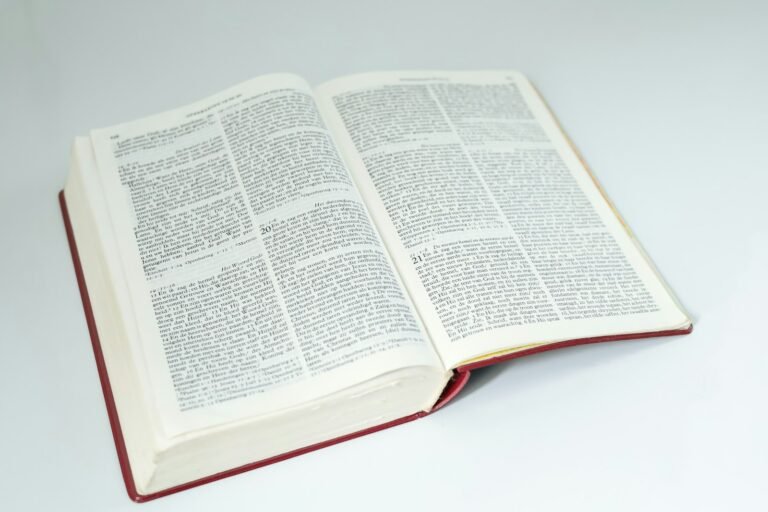 an open book sitting on top of a white table